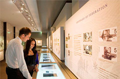 Man and woman looking at historic banknotes in Museum.